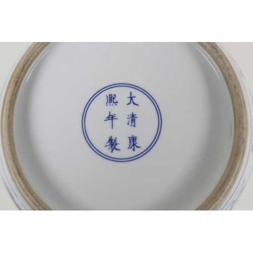 35 - A blue and white porcelain jardiniere decorated with travellers, Chinese KangXi 6 character mark to ... 