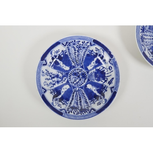 48 - A pair of blue and white porcelain cabinet dishes decorated with figures in a garden, Chinese 4 char... 