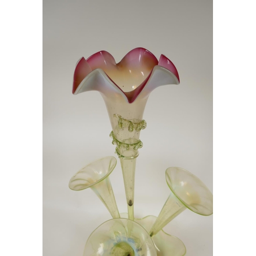 5 - A Victorian vaseline glass epergne with four trumpets, on a petal bowl base, 21