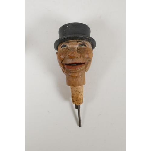 51 - A set of four carved and painted Black Forest figural caricature bottle stoppers/pourers, in a wall ... 