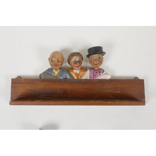 51 - A set of four carved and painted Black Forest figural caricature bottle stoppers/pourers, in a wall ... 