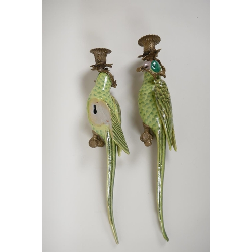 53 - A pair of polychrome porcelain parakeet wall sconces with gilt metal mounts, 18½