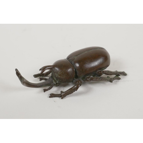 8 - A Japanese bronze okimono in the form of a horned beetle, impressed mark to base, 3