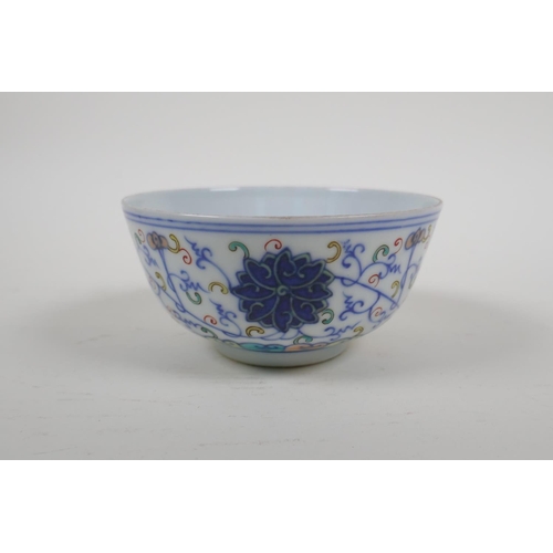 15 - A Chinese polychrome porcelain rice bowl with scrolling lotus flower decoration, early C20th, Guangx... 