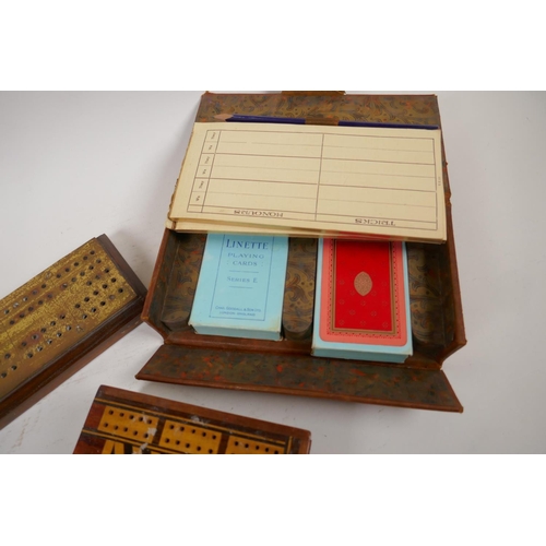 17 - Two bridge card boxes containing cards and score sheets, a wooden bridge marker, a brass and wood cr... 