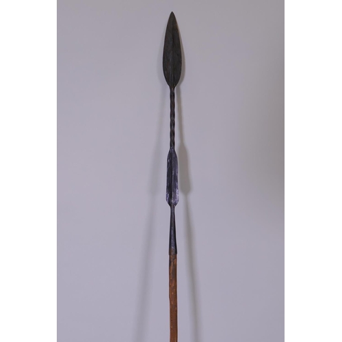 22 - An early C20th African Maasai hunting spear, the tip with double edged leaf point and the butt forme... 