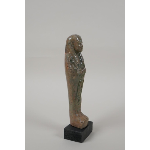 13 - An Egyptian turquoise glazed faience shabti, mounted on a display base, 7