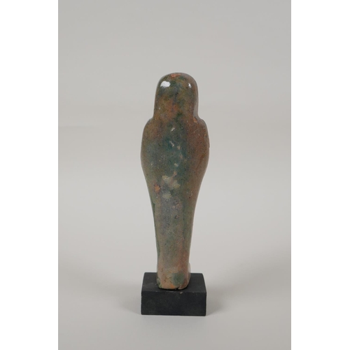 13 - An Egyptian turquoise glazed faience shabti, mounted on a display base, 7