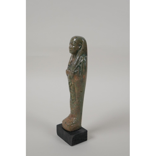 13 - An Egyptian turquoise glazed faience shabti, mounted on a display base, 7