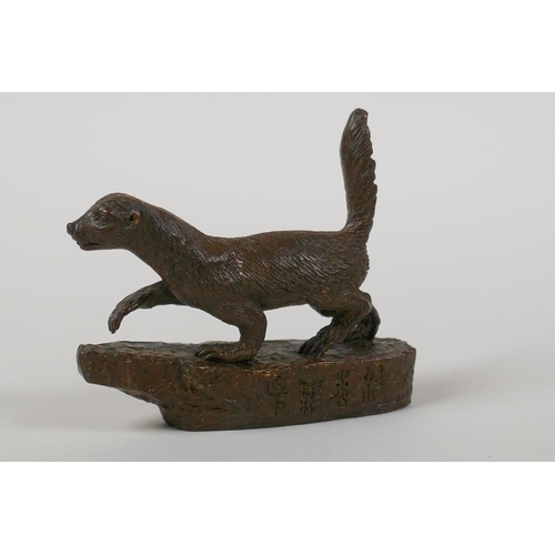 23 - A Japanese bronze okimono of an otter, indistinct character script to side, 2½