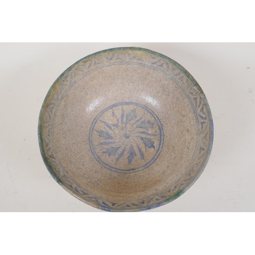 25 - A Persian earthenware bowl with painted leaf decoration within a patterned border, 8