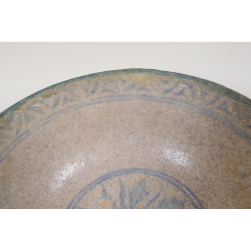 25 - A Persian earthenware bowl with painted leaf decoration within a patterned border, 8