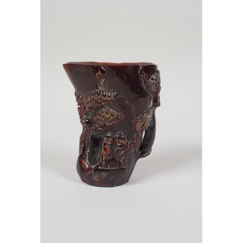 33 - A Chinese carved horn libation cup, decorated with figures beneath trees, inscribed 4 character mark... 