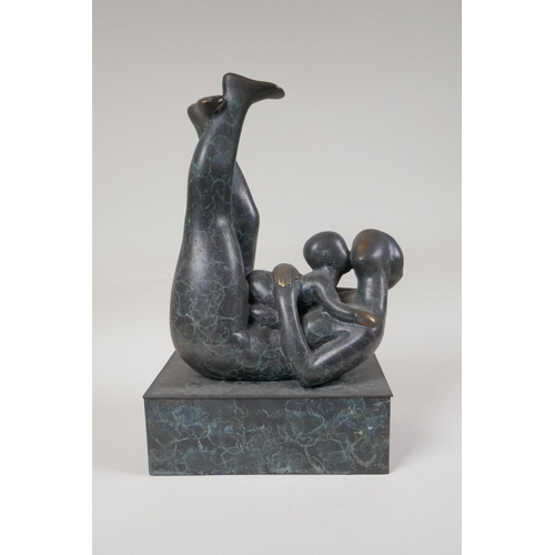 34 - A modernist patinated bronze figure of a mother and child embracing, 12½