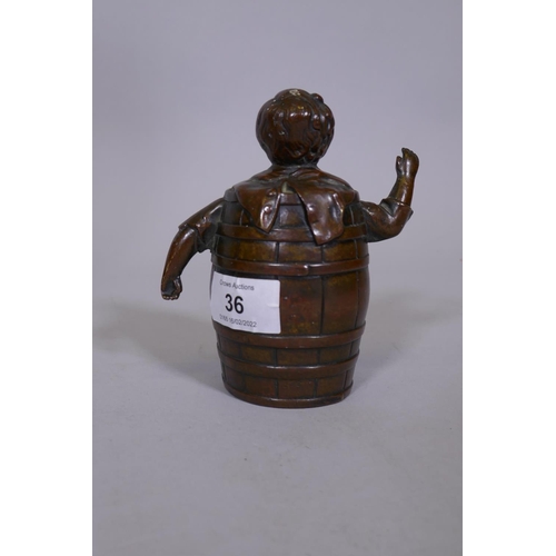 36 - An antique bronze hand bell in the form of a boy in a barrel, 5