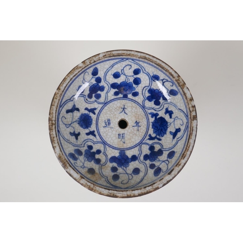 38 - A Chinese crackleware censer/taper holder with blue and white decoration of figures in a garden, 4 c... 