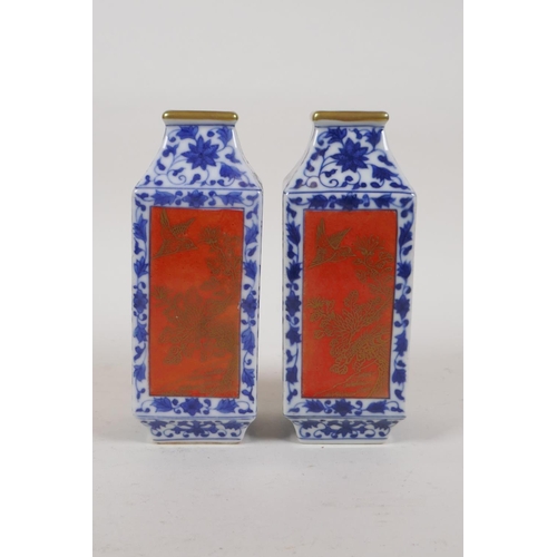 40 - A pair of blue and white porcelain vases with red and gilt decorative panels depicting birds and flo... 