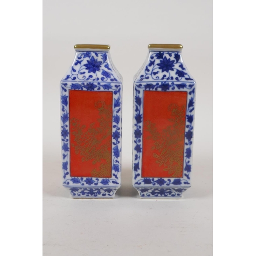 40 - A pair of blue and white porcelain vases with red and gilt decorative panels depicting birds and flo... 