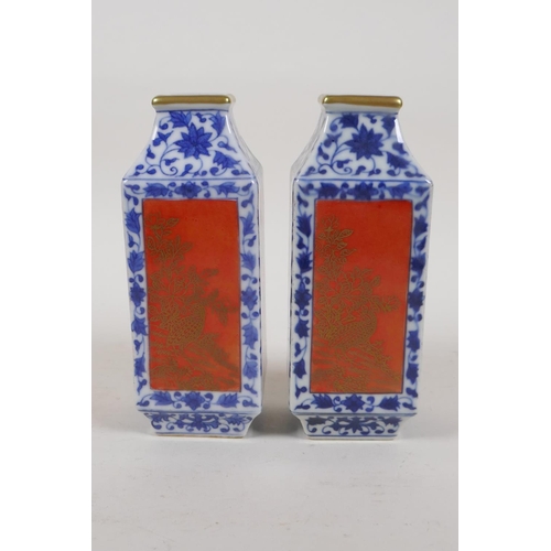 40 - A pair of blue and white porcelain vases with red and gilt decorative panels depicting birds and flo... 