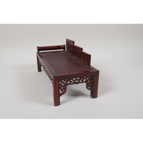 43 - A Chinese carved hardwood miniature day bed, 9