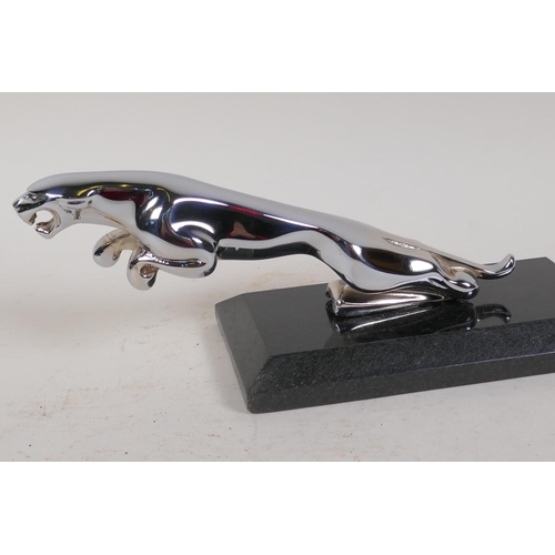 46 - A replica chrome plated Jaguar car mascot, on marble base, 9