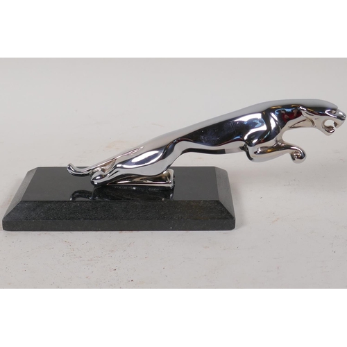 46 - A replica chrome plated Jaguar car mascot, on marble base, 9