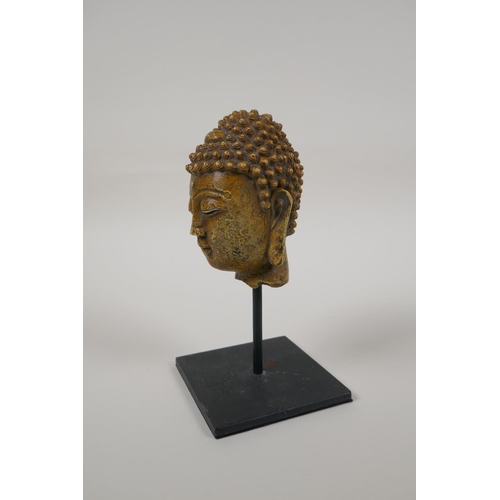 48 - A Chinese reconstituted stone bust of Buddha, on a display mount, 7