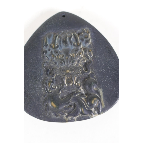 5 - A Chinese carved hoof pendant with stylised dragon decoration and another similar, 2½