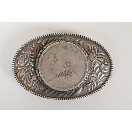 58 - A Chinese white metal belt buckle decorated with a facsimile coin, and a white metal scent diffuser ... 