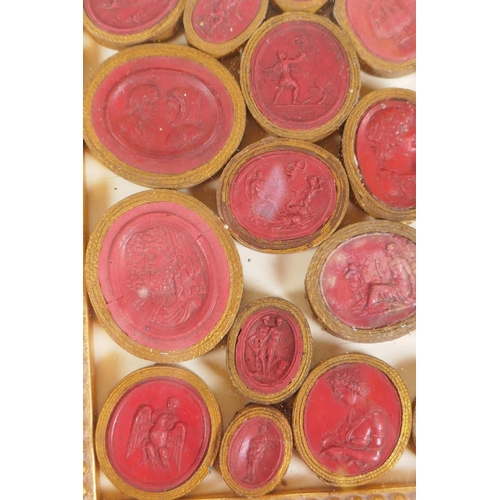 1 - A framed collection of Grand Tour red wax intaglios depicting classical figures, each individually w... 