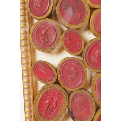 1 - A framed collection of Grand Tour red wax intaglios depicting classical figures, each individually w... 