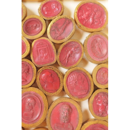 1 - A framed collection of Grand Tour red wax intaglios depicting classical figures, each individually w... 