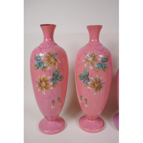 12 - A pair of C19th pink milk glass vases, painted with flowers, 12½