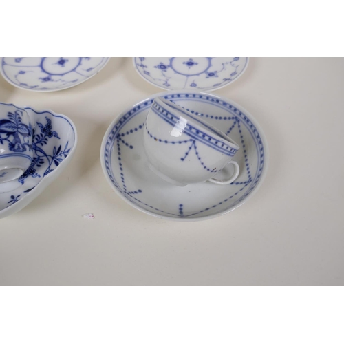 24 - A Meissen onion pattern blue and white porcelain petal shaped cup and saucer, AF, an early Copenhage... 