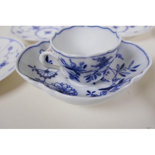 24 - A Meissen onion pattern blue and white porcelain petal shaped cup and saucer, AF, an early Copenhage... 