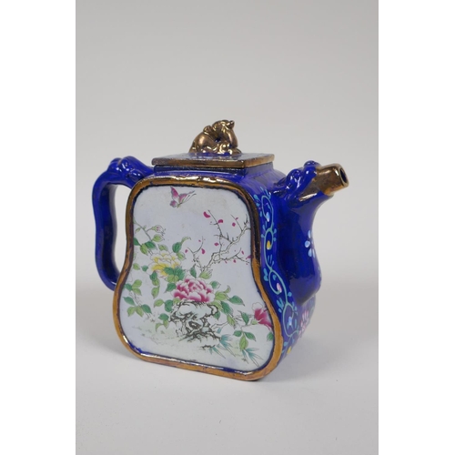 25 - A Chinese blue and gilt enamelled Yixing teapot, with famille rose decorative panels depicting birds... 