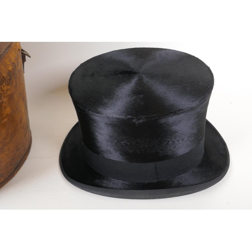 31 - A silk top hat by Henry Heath Ltd in a leather fitted hat box