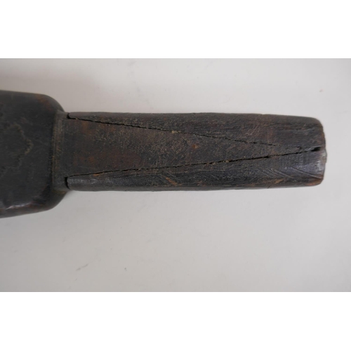 41 - A New Guinea carved wood 'Massim' club, inscribed to the paddle, 23½