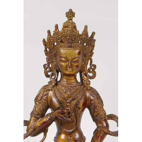 50 - A Sino Tibetan gilt bronze of Buddha carrying two vajra, 12