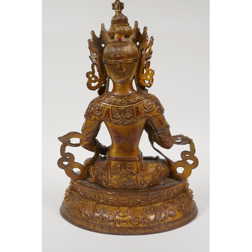 50 - A Sino Tibetan gilt bronze of Buddha carrying two vajra, 12