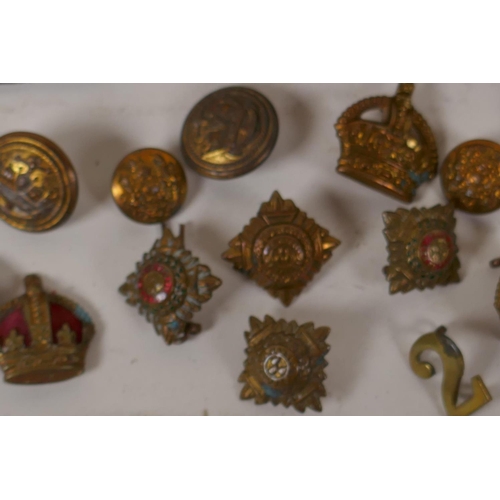 51 - A box of military buttons, badges and epaulettes