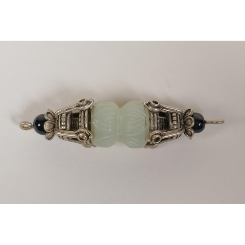 53 - A Tibetan white metal and jade vajra style pendant and a Chinee carved hardstone pendant with dragon... 