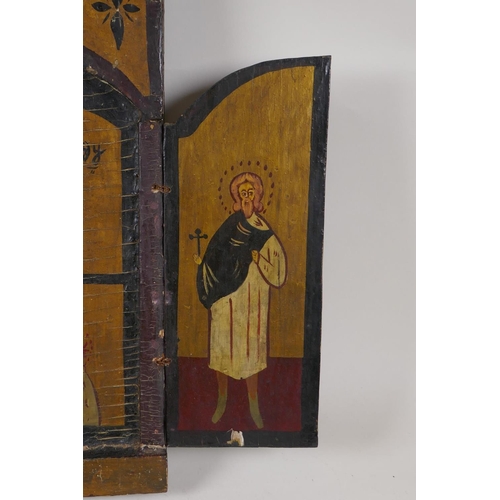 54 - An antique coptic triptych icon, 19½