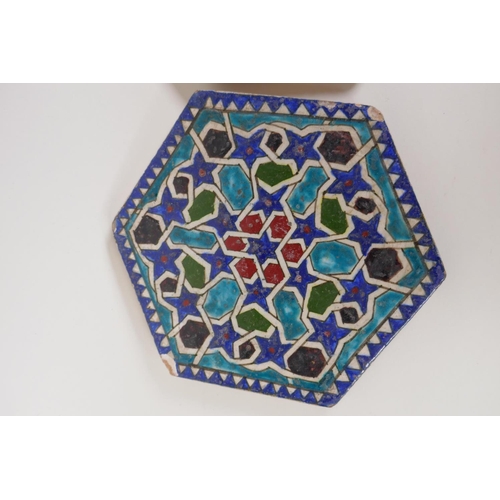 57 - A pair of Persian hexagonal stoneware tiles painted with geometric patterns, 7