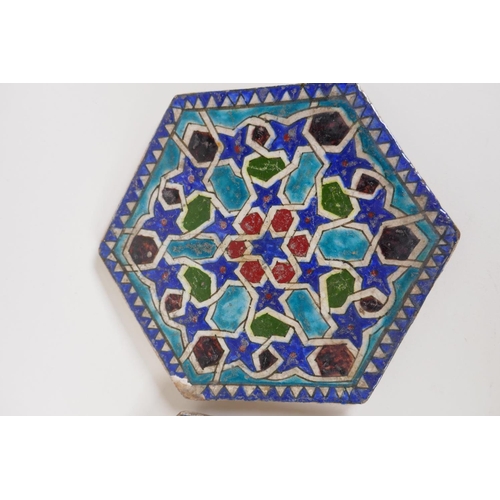 57 - A pair of Persian hexagonal stoneware tiles painted with geometric patterns, 7