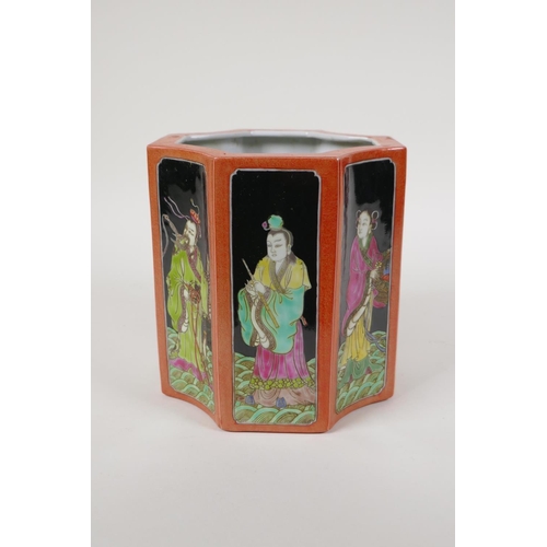 58 - A polychrome porcelain brush pot, decorated with famille noir panels depicting the eight immortals, ... 