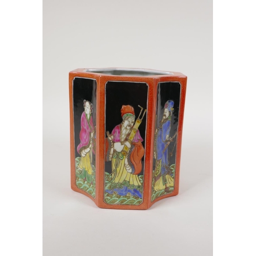 58 - A polychrome porcelain brush pot, decorated with famille noir panels depicting the eight immortals, ... 