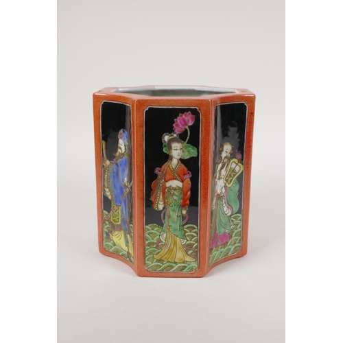 58 - A polychrome porcelain brush pot, decorated with famille noir panels depicting the eight immortals, ... 