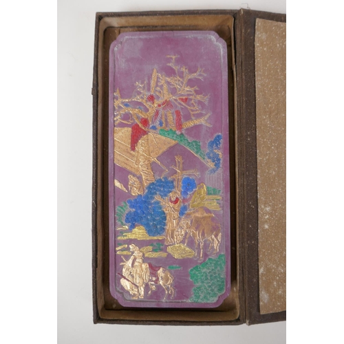 60 - A Chinese mauve ground ink stone decorated with farming figures highlighted in gilt, boxed, 4½... 