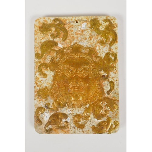 8 - A Chinese hardstone tablet with carved and gilt mask and kylin decoration, 3½